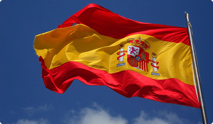 A spanish flag flying in the sky.